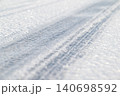 Tire tracks on an icy frozen road, close up. Winter season, slippery road, dangerous for driving 140698592