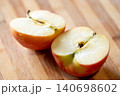 Close up of red apple cut into two halves, laying on the table. Ripe fruit, full of vitamins, ready to eat 140698602