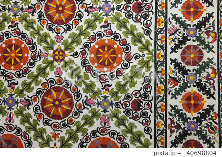 Colorful embroidered Suzani textile featuring traditional floral motifs Colorful embroidered Suzani textile featuring traditional floral motifs 140698804