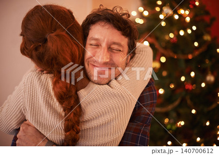Couple, Christmas and hug to celebrate holiday, festive season of giving for love and commitment. Happiness, gratitude and support with people at home, romance and relationship with peace together 140700612