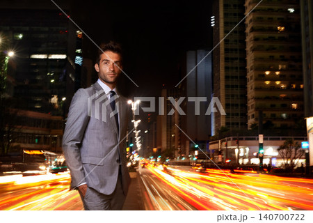 Businessman, portrait and city lights at night with traffic as financial advisor for corporate professional, building or late. Male person, face and suit with motion blur on urban, street or commute Businessman, portrait and city lights at night with traffic as financial advisor for corporate professional, building or late. Male person, face and suit with motion blur on urban, street or commute 140700722