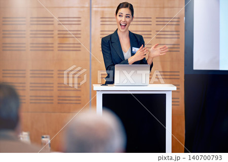 Happy woman, laptop and business presentation with projector in meeting, discussion or seminar at conference. Young female person, employee or speaker talking on podium to group in corporate workshop Happy woman, laptop and business presentation with projector in meeting, discussion or seminar at conference. Young female person, employee or speaker talking on podium to group in corporate workshop 140700793