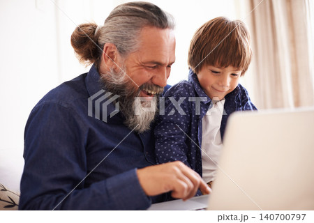 Smile, laptop and grandfather with boy and games, playing and fun in home living room. Happy, streaming or elearning online and internet in house with child, technology and computer for learning Smile, laptop and grandfather with boy and games, playing and fun in home living room. Happy, streaming or elearning online and internet in house with child, technology and computer for learning 140700797