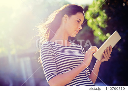 Woman, tablet or social media for networking in nature, outdoor or search of travel app for tourist. Young person, touchscreen or scroll online for connectivity or reading message or email for update 140700810