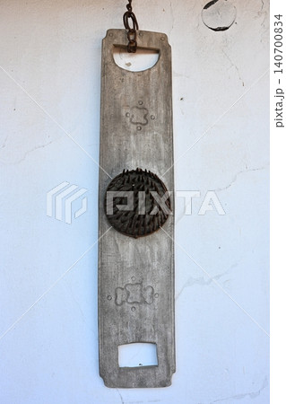 Antique Wooden Flax Comb or Carding Tool Hanging on White Wall 140700834