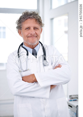 Senior man, doctor and portrait with arms crossed in office for healthcare, medical support and medicine career. Mature, face and health expert with smile or confidence with stethoscope in hospital 140700886
