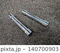Chrome dumbbells on dark grey gym carpet background 140700903