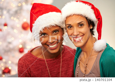 Friends, hat and portrait by Christmas tree in home, smile and excited for festive season. Women, religious holiday and ready for celebration in living room, happy and traditional fashion on vacation Friends, hat and portrait by Christmas tree in home, smile and excited for festive season. Women, religious holiday and ready for celebration in living room, happy and traditional fashion on vacation 140701104