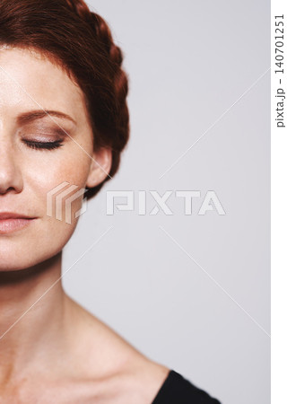 Half face, beauty and space with woman in studio isolated on white background for natural wellness. Skincare, hair and makeup with confident mature model on mockup for antiaging facial treatment Half face, beauty and space with woman in studio isolated on white background for natural wellness. Skincare, hair and makeup with confident mature model on mockup for antiaging facial treatment 140701251
