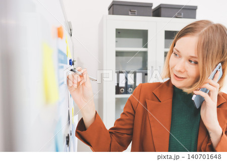 Woman smiling to herself as she works in an office 140701648
