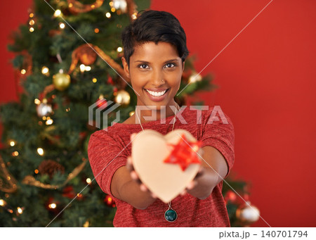 Christmas, heart and portrait of happy woman with gift in box or package at home for holiday celebration on mockup space in India. Xmas, face and giving present for love on festive season in house Christmas, heart and portrait of happy woman with gift in box or package at home for holiday celebration on mockup space in India. Xmas, face and giving present for love on festive season in house 140701794