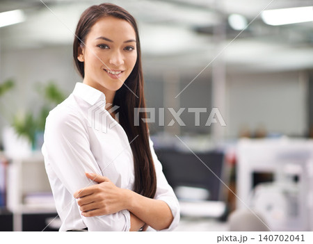 Portrait, young and businesswoman with confidence in office, arms crossed and professional with ambition. Happy person, smile face and hr consultant with job satisfaction and pride in career at work 140702041