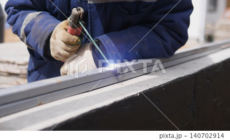 Closeup Fabricator Using Welding Torch On Metal Frame, Sparks And Heat At Joint, Gloved Hands Steadying Fixture, Workshop And Onsite Assembly Combined In Practical Fabrication Scene Closeup Fabricator Using Welding Torch On Metal Frame, Sparks And Heat At Joint, Gloved Hands Steadying Fixture, Workshop And Onsite Assembly Combined In Practical Fabrication Scene 140702914