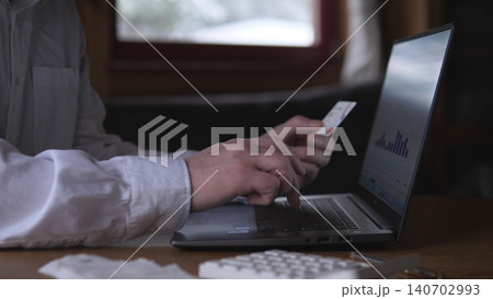 Hands Entering Card Details On Laptop, White Shirt Sleeve Visible, Checkout Form And Secure Payment Context, Focused Closeup Of Ecommerce Purchase And Verification Stage Hands Entering Card Details On Laptop, White Shirt Sleeve Visible, Checkout Form And Secure Payment Context, Focused Closeup Of Ecommerce Purchase And Verification Stage 140702993