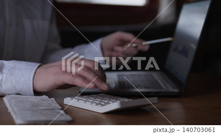 Reconciling Invoices With Calculator And Laptop, White Shirt Sleeve, Pen In Hand And Scattered Receipts, Closeup Bookkeeper Scene Focused On Balancing Accounts And Verifying Totals, Steady Reconciling Invoices With Calculator And Laptop, White Shirt Sleeve, Pen In Hand And Scattered Receipts, Closeup Bookkeeper Scene Focused On Balancing Accounts And Verifying Totals, Steady 140703061