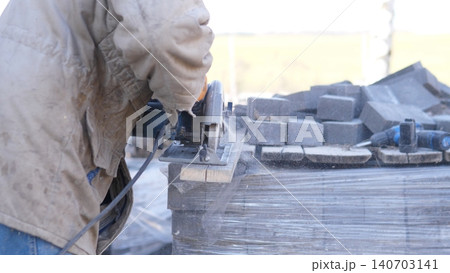 Construction Worker Meticulously Arranges And Prepares Materials For Transportation. Onsite Worker Sorts And Readies Paving Edges And Blocks For Efficient Loading And Stacking Construction Worker Meticulously Arranges And Prepares Materials For Transportation. Onsite Worker Sorts And Readies Paving Edges And Blocks For Efficient Loading And Stacking 140703141
