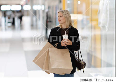 Woman enjoying retail therapy and window shopping at mall 140703333