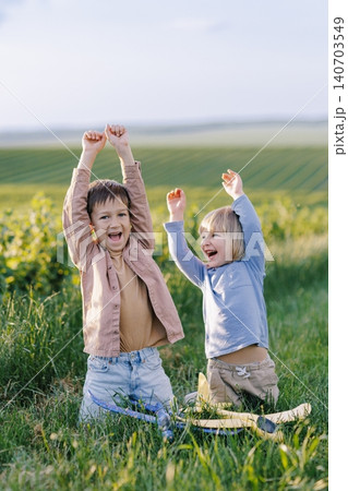 Happy children celebrating success and playing outdoors Happy children celebrating success and playing outdoors 140703549