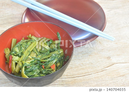 stir fried slice Chinese morning glory with chili in soybean paste on bowl with chopsticks 140704035