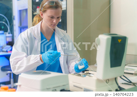 Scientist conducting research in a modern laboratory with advanced technology and equipment for scientific studies Scientist conducting research in a modern laboratory with advanced technology and equipment for scientific studies 140704223