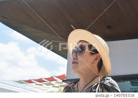 elder woman strong and healthy wearing hat in community mall garden elder woman strong and healthy wearing hat in community mall garden 140705316
