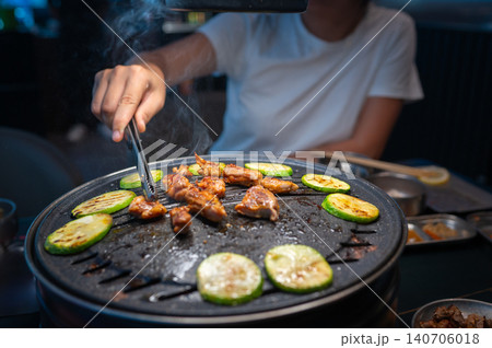 Grilling Chicken and Vegetables on a Korean BBQ Table with Steam Grilling Chicken and Vegetables on a Korean BBQ Table with Steam 140706018