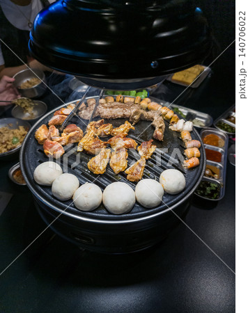 Grilled Seafood and Meat on Korean BBQ Grill with Side Dishes Grilled Seafood and Meat on Korean BBQ Grill with Side Dishes 140706022