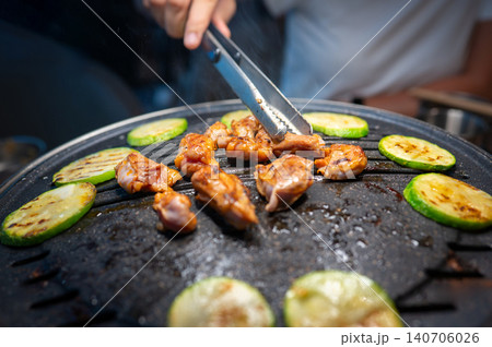 Grilling Chicken and Vegetables on a Korean BBQ Table with Steam Grilling Chicken and Vegetables on a Korean BBQ Table with Steam 140706026