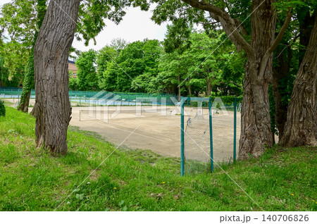 The scene of tennis court in a public park in Japan. Tennis court outdoor in the daytime. Travel and nature scene. The scene of tennis court in a public park in Japan. Tennis court outdoor in the daytime. Travel and nature scene. 140706826