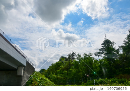 The scenery of the countryside during the roadtrip with stunning scenery of Sapporo, Hokkaido, Japan. Stunning cloudscape with beautiful landscape. Nature and Travel scene. 140706926