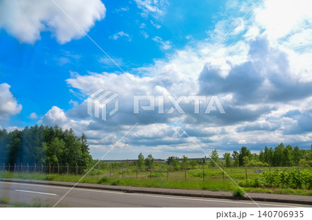 The scenery of the countryside during the roadtrip with stunning scenery of Sapporo, Hokkaido, Japan. Stunning cloudscape with beautiful landscape. Nature and Travel scene. The scenery of the countryside during the roadtrip with stunning scenery of Sapporo, Hokkaido, Japan. Stunning cloudscape with beautiful landscape. Nature and Travel scene. 140706935