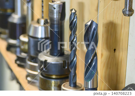 Close-up of a group of industrial drill tools assembled with tool holders installed on a machine shaft. Close-up of a group of industrial drill tools assembled with tool holders installed on a machine shaft. 140708223