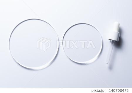 Glass circles on a blue background. A template for placing samples of cosmetics or medical products or food. Glass circles on a blue background. A template for placing samples of cosmetics or medical products or food. 140708473