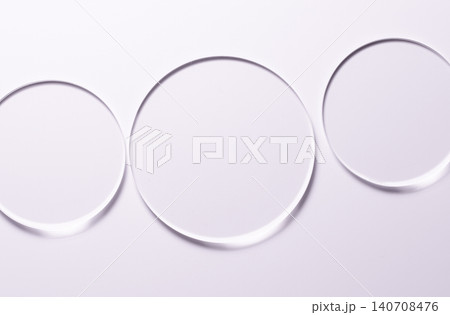 Glass circles on a pink background. A template for placing samples of cosmetics or medical products or food. 140708476
