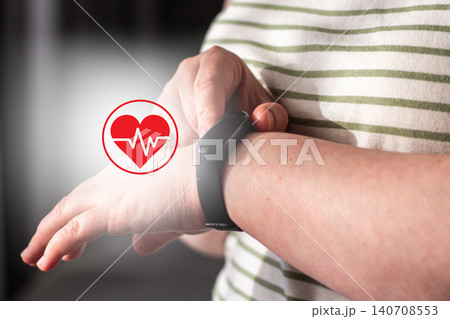 Woman checks health indicators using tracking app on smartwatch. Smart health means using devices as assistants not overlords. Low alarm high-awareness living. Digital detox concept Woman checks health indicators using tracking app on smartwatch. Smart health means using devices as assistants not overlords. Low alarm high-awareness living. Digital detox concept 140708553