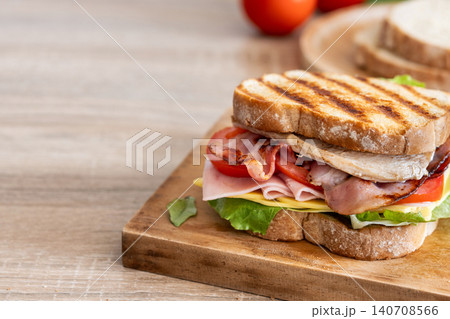 Club Sandwich with Bacon, Ham, Cheese and Chicken Club Sandwich with Bacon, Ham, Cheese and Chicken 140708566