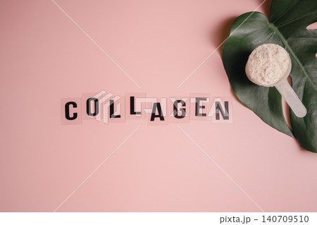 Collagen powder in a scoop, food supplement concept, with tropical leafe on pink background, wellness pink concept Collagen powder in a scoop, food supplement concept, with tropical leafe on pink background, wellness pink concept 140709510