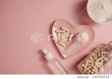 Collagen powder, capsules and serum bottle on pink background, flat lay with copy space Collagen powder, capsules and serum bottle on pink background, flat lay with copy space 140709513