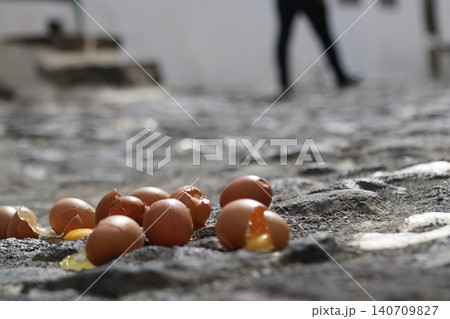 Broken eggs lying on a rough cobblestone pavement Broken eggs lying on a rough cobblestone pavement 140709827