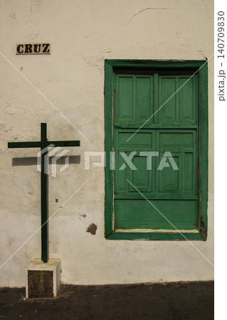 Cruz sign and green window shutters on old wall Cruz sign and green window shutters on old wall 140709830