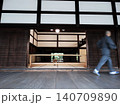 Monk walking with motion blur in zen temple corridor 140709890