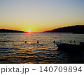 Boat floating on water during tranquil sea sunset 140709894