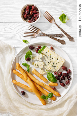 Gourmet blue cheese and breadsticks with olives Gourmet blue cheese and breadsticks with olives 140709930