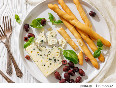 Italian blue cheese platter with grissini and olives Italian blue cheese platter with grissini and olives 140709932