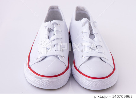 Pair of White Canvas Sneakers background Pair of White Canvas Sneakers background 140709965