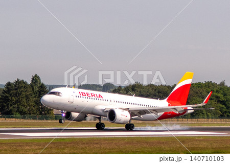 Iberia Airbus A320neo airplane landing on a runway Iberia Airbus A320neo airplane landing on a runway 140710103