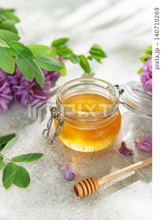 Natural acacia honey in a jar with flowers 140710269