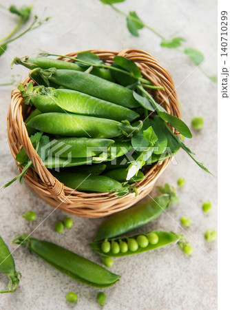 Fresh green pea pods in basket representing healthy eating Fresh green pea pods in basket representing healthy eating 140710299
