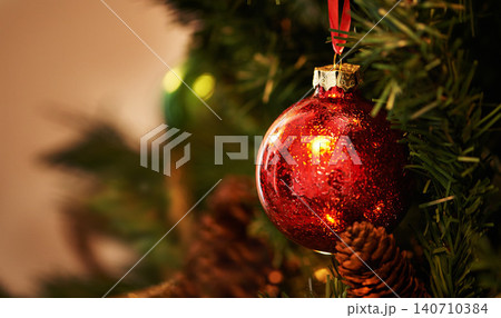 Christmas, tree and red ornament for holiday, celebration and closeup with tradition or festive season at home. Decorations, detail and event with glitter ball, circle or sphere for xmas background Christmas, tree and red ornament for holiday, celebration and closeup with tradition or festive season at home. Decorations, detail and event with glitter ball, circle or sphere for xmas background 140710384