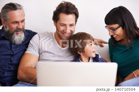 Family, laptop and young boy or streaming on couch, smile and bonding in living room. Video call, technology and happy grandfather with parents on sofa, computer and communication online in lounge Family, laptop and young boy or streaming on couch, smile and bonding in living room. Video call, technology and happy grandfather with parents on sofa, computer and communication online in lounge 140710504
